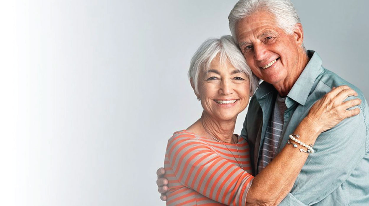 Smiling elderly couple embracing each other