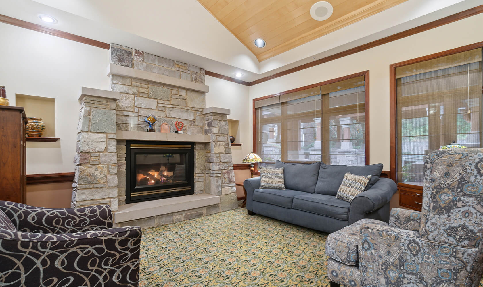 Community sitting room with a large stone fireplace