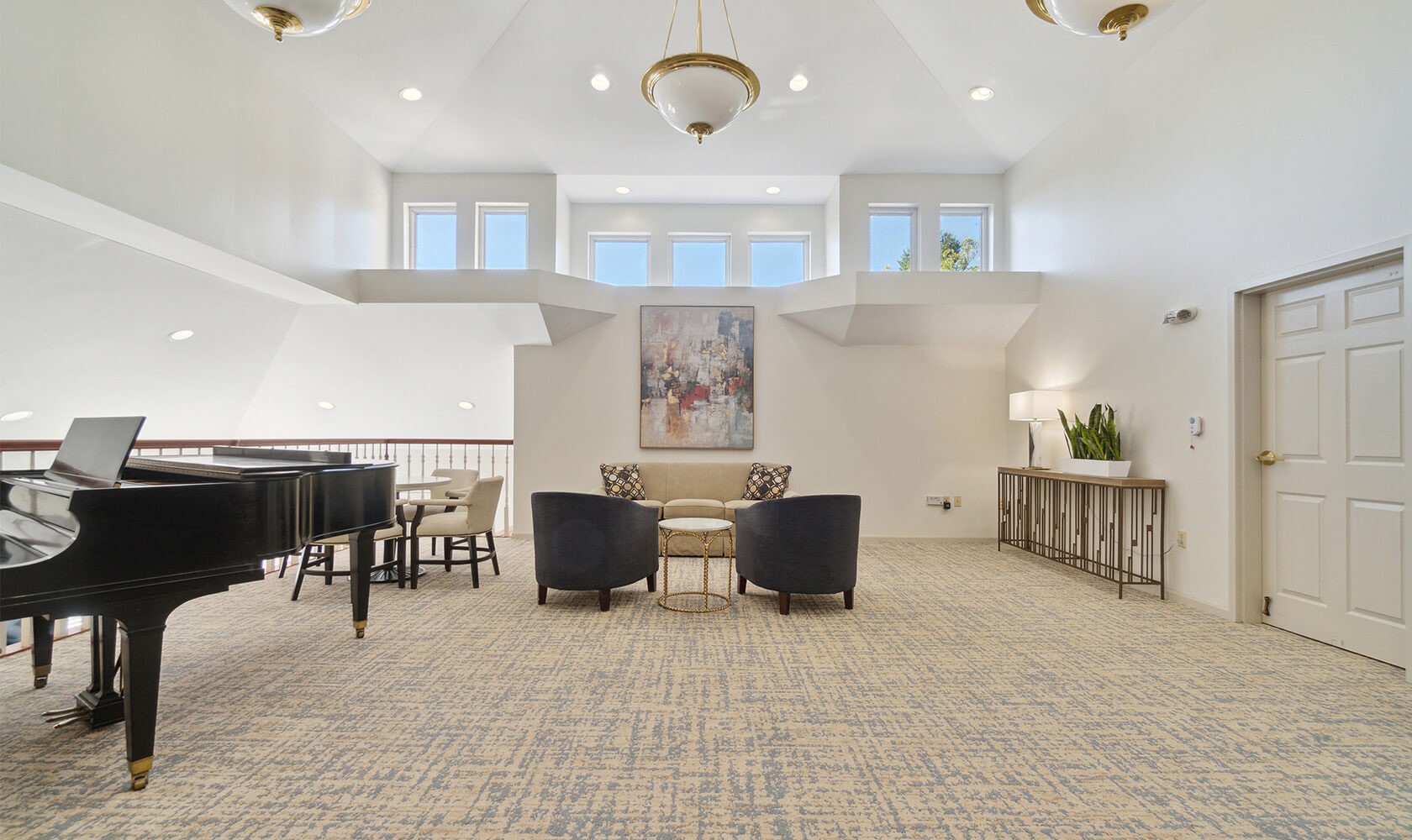 Bright seating area with large piano