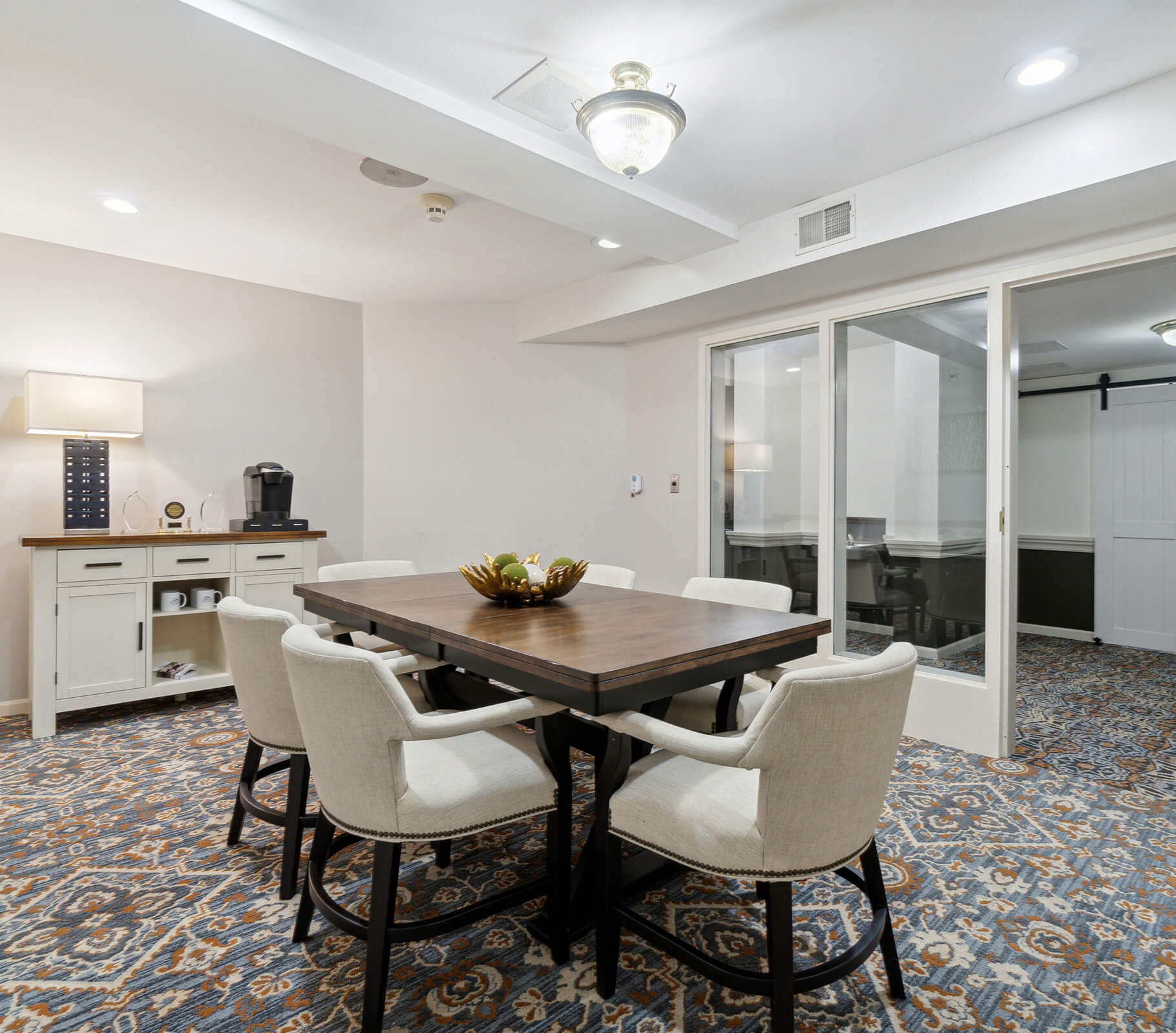 Cozy dining area in senior living community with elegant decor and a coffee station.