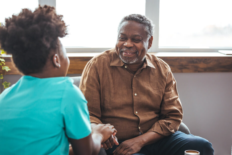 Senior man shaking young nurse's hand