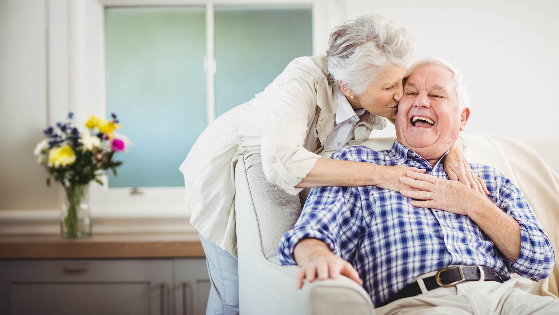 Senior woman kissing husbands cheek