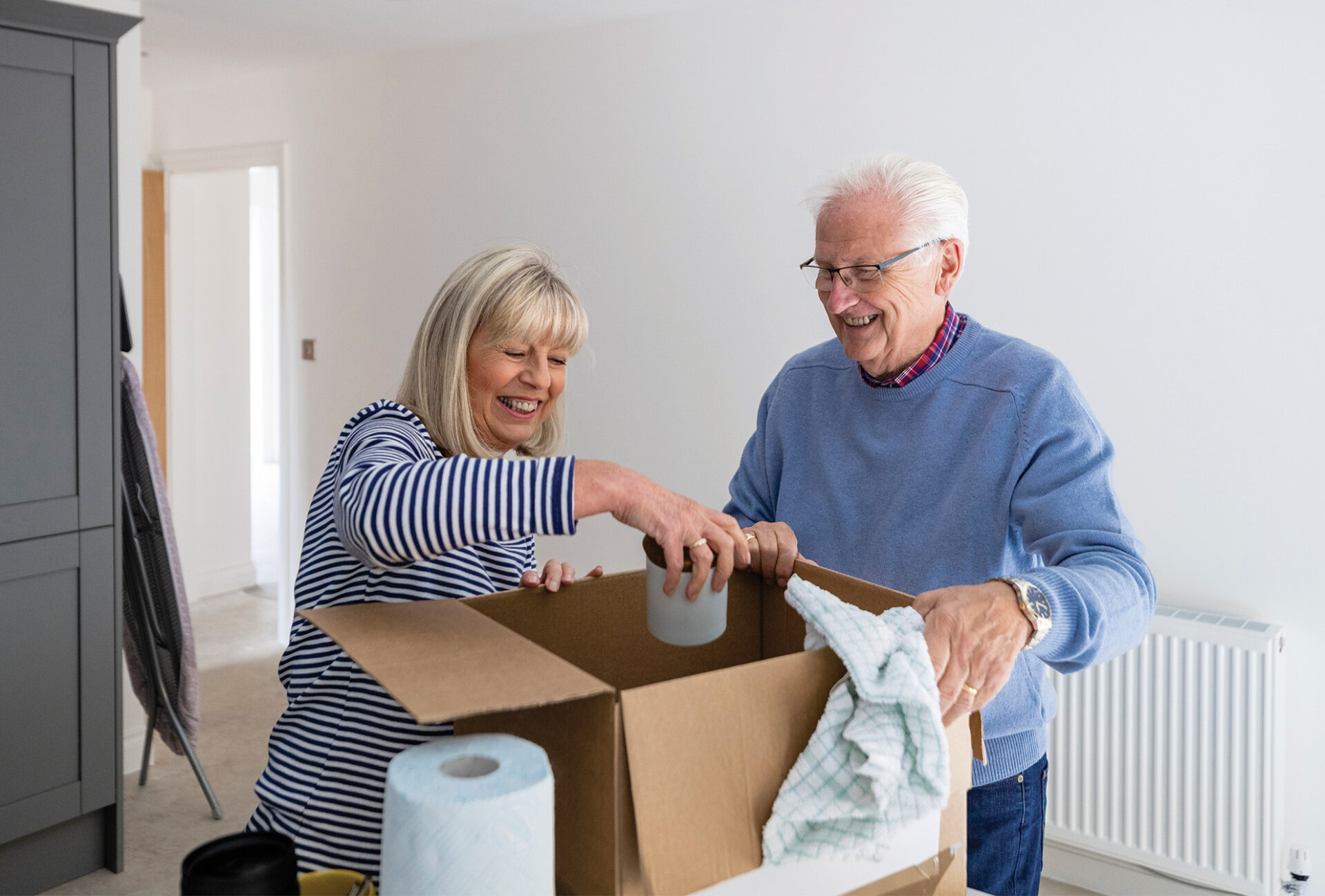 seniors downsizing items as they pack for moving